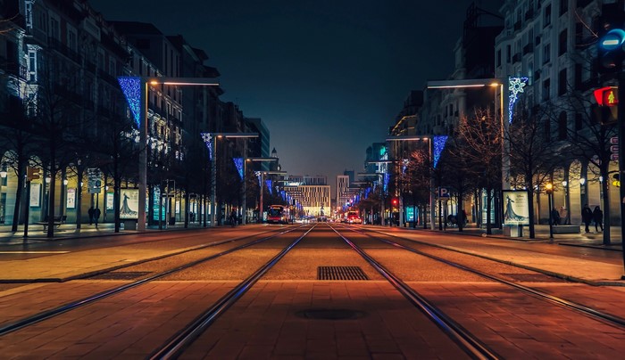 Street with tram tracks at night in Zaragoza, Spain