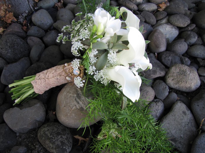 White calla lily and freesia bouquet on rocks