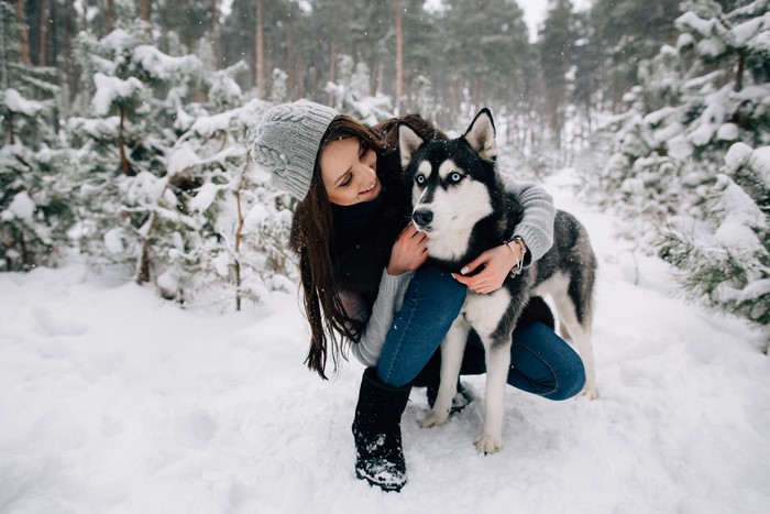 Girl with Husky in Snowy Forest