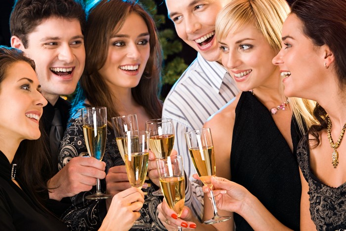 Group of friends celebrating with champagne