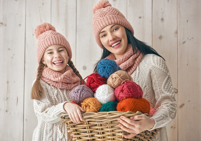 Mother and daughter with basket of yarn