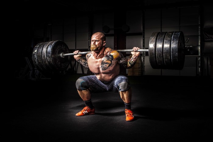 Man performing a heavy barbell squat