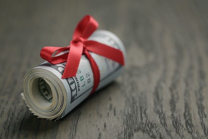 Rolled US Dollars Tied with Red Ribbon