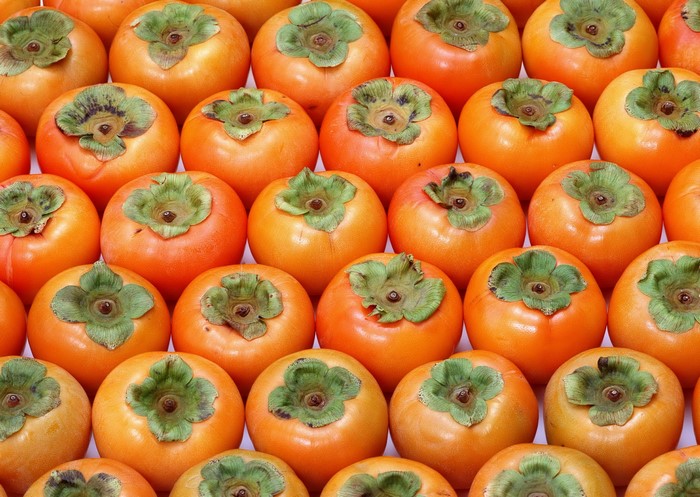 Close-up of a pile of ripe persimmons