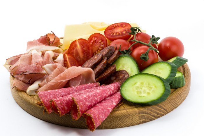 4K charcuterie board with meats, cheese, tomatoes, and cucumbers