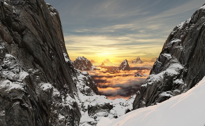 Snow-capped mountains at sunrise over clouds