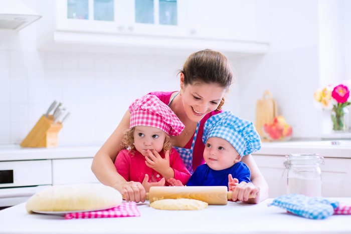 Mother and two children baking in a kitchen