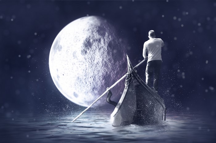 Man rowing a boat under the moon