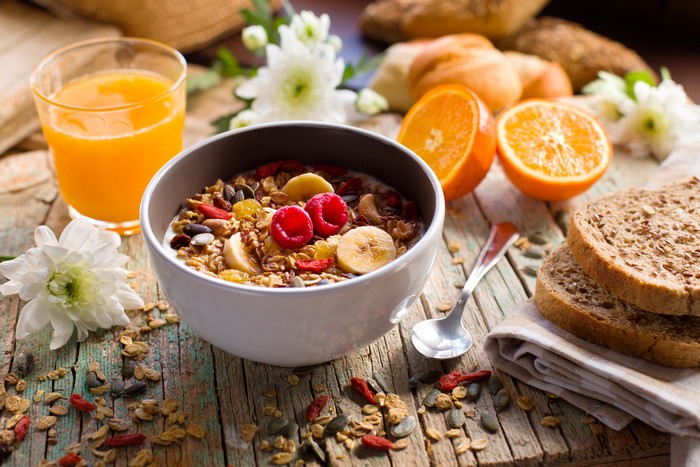 Muesli with fruit and orange juice for breakfast
