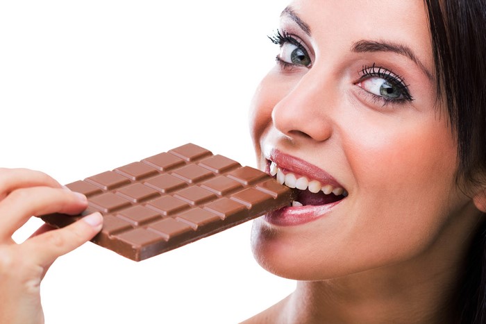 Woman eating a chocolate bar