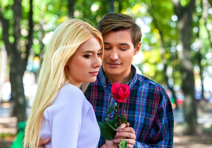 Couple with a rose in a park