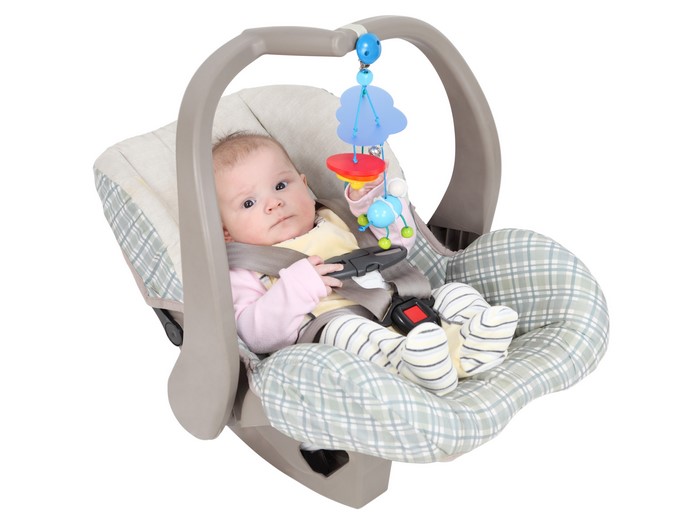 Baby in a car seat with toys