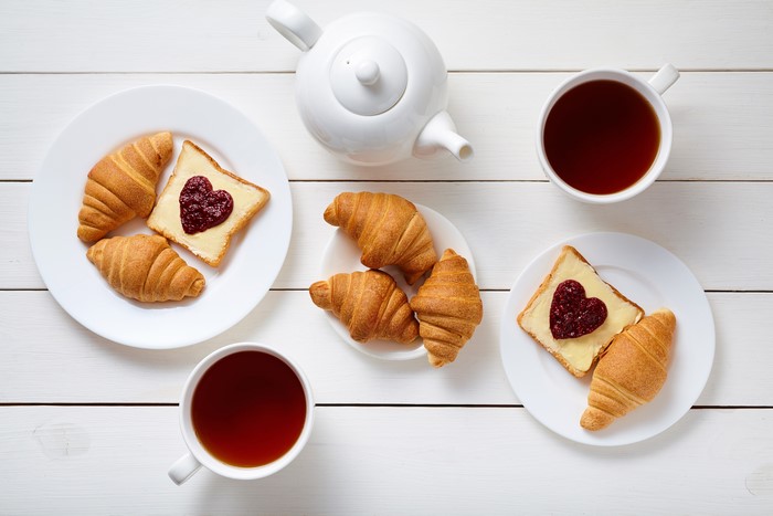Breakfast with Tea, Croissants, and Heart-Shaped Jam Toast
