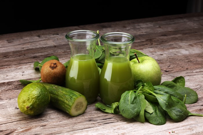 Green Juice with Fruits and Vegetables on Wood