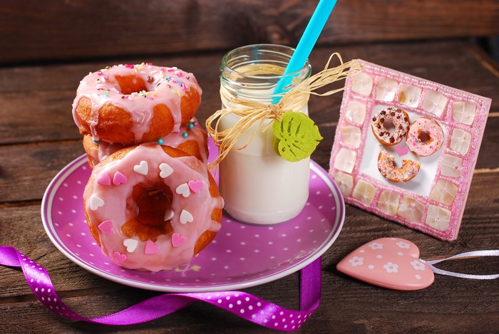 Pink Frosted Donuts with Milk and Decorations