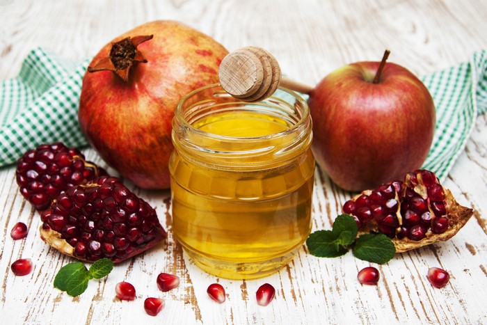 Honey, Apples, and Pomegranates on Wood
