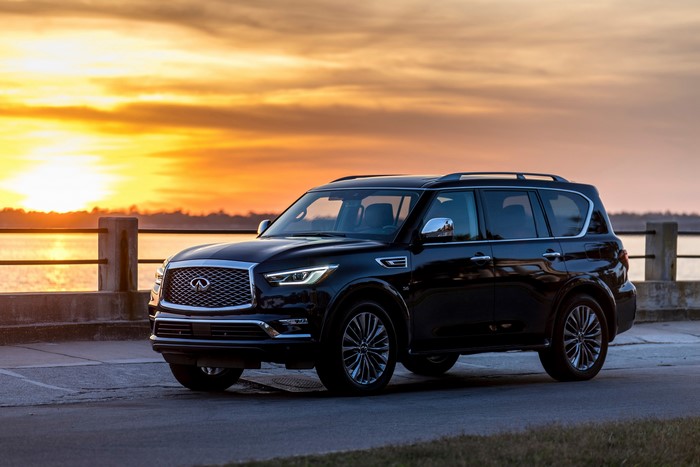 Black Infiniti QX80 SUV at sunset