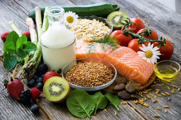 Assortment of Healthy Foods: Salmon, Fruits, Vegetables, Milk, and Grains