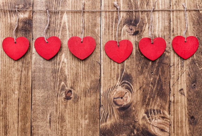 Red hearts hanging on wooden planks