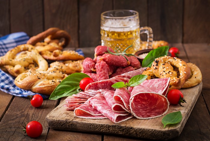 Sausage, Pretzels, and Beer on a Cutting Board