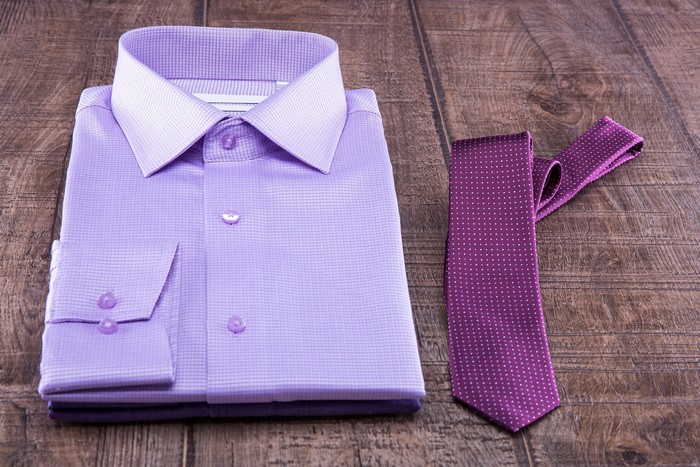 Violet formal shirt and necktie on wood planks