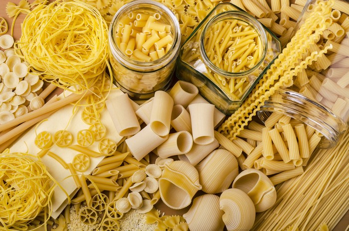 Assortment of Dry Pasta in Jars and Scattered