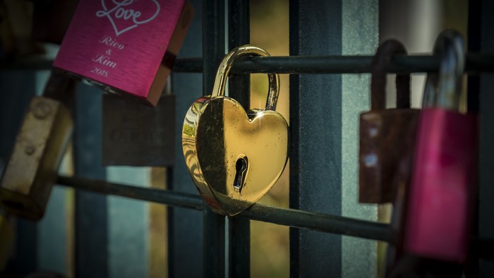 Gold Heart Padlock on a Fence