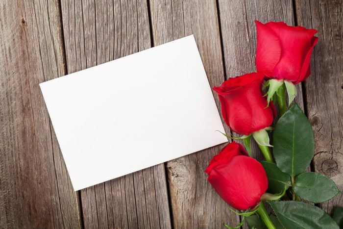 Red Roses and Blank Card on Wood