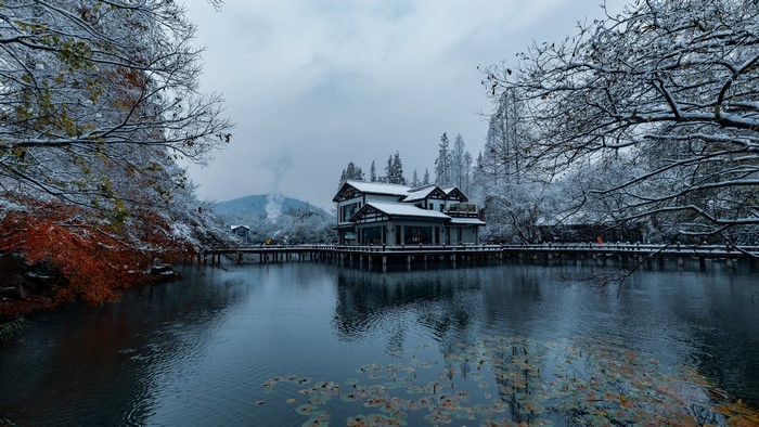 Winter snow scene with a house on a lake in China