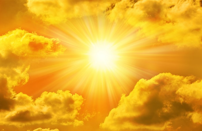 Sun shining through golden clouds