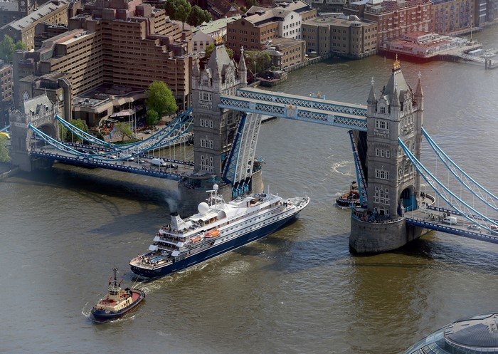Cruise ship passing under Tower Bridge, London