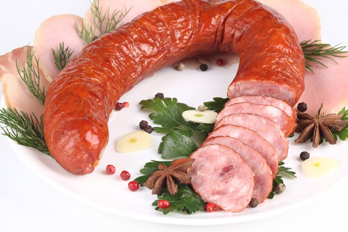 Sausage and ham with spices on a white background