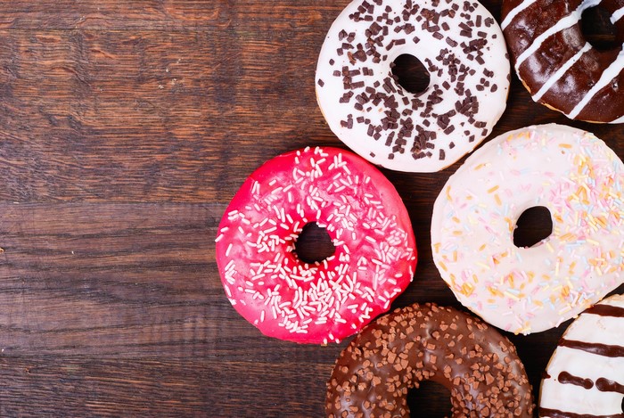 Assortment of colorful donuts on a wooden table
