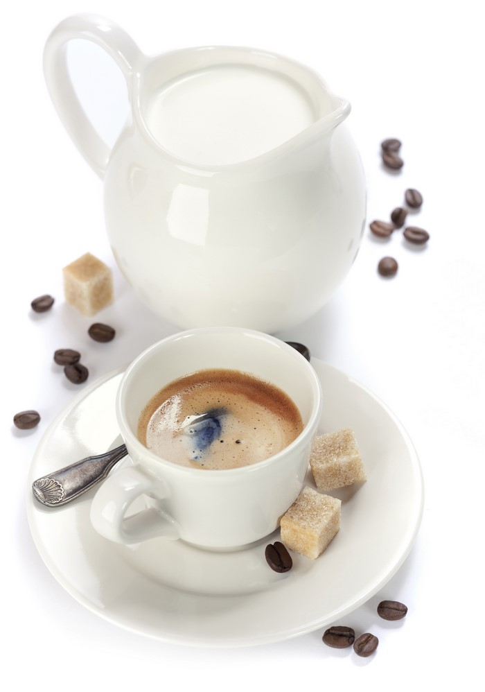 Espresso cup with milk jug and sugar cubes