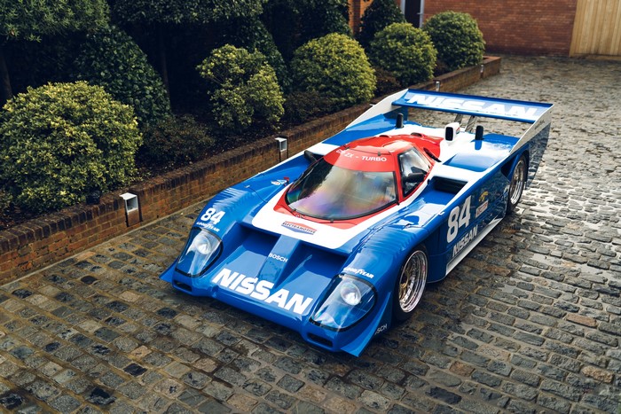 Nissan GTP ZX-Turbo race car on cobblestone driveway