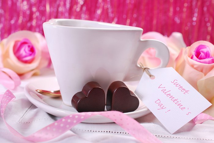 Valentine's Day cup with chocolates and roses