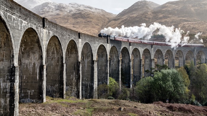 Steam train crossing Glenfinnan Viaduct, Scotland