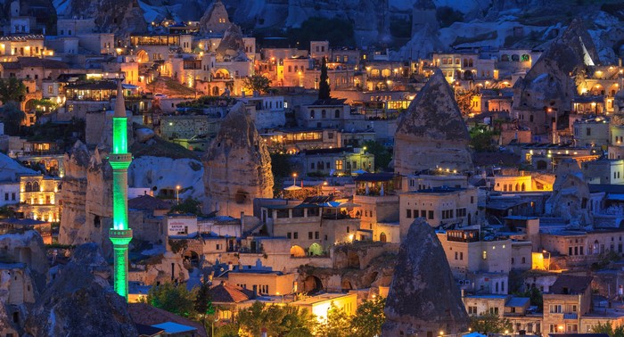 Goreme, Turkey at Evening with Lit Minaret