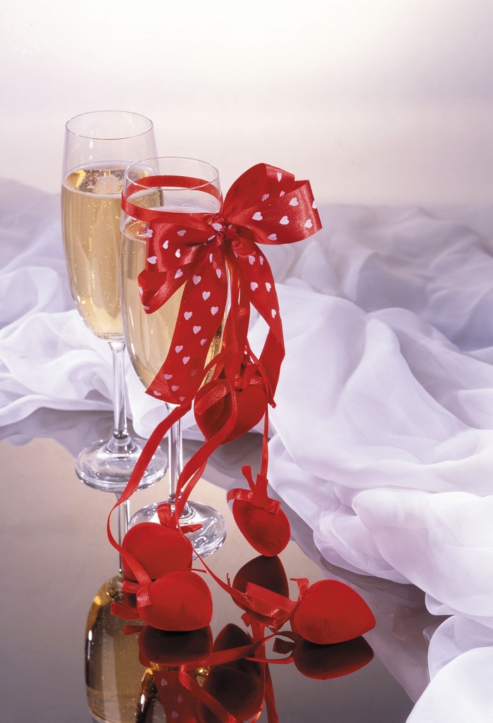 Champagne glasses with red heart ribbon and decorations