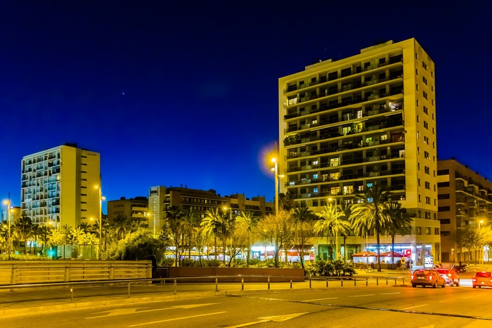 Apartment buildings and palm trees at night