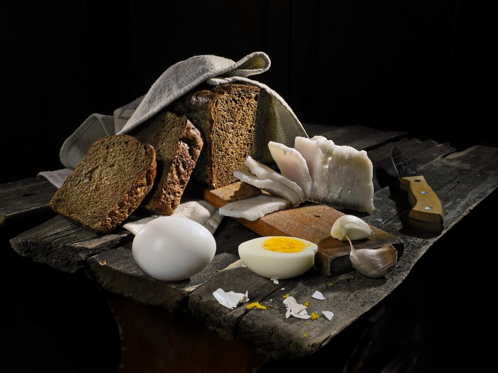 Still life with bread, salo, egg, and garlic