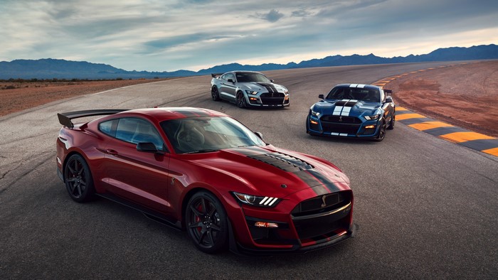 Three Ford Mustang Shelby GT500 cars on a track