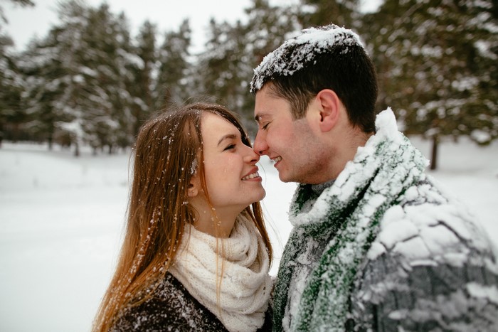Couple in love in a snowy forest