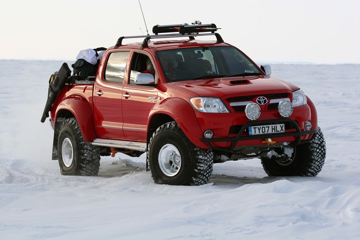 Red Toyota Hilux Invincible AT38 Arctic Truck in Snow