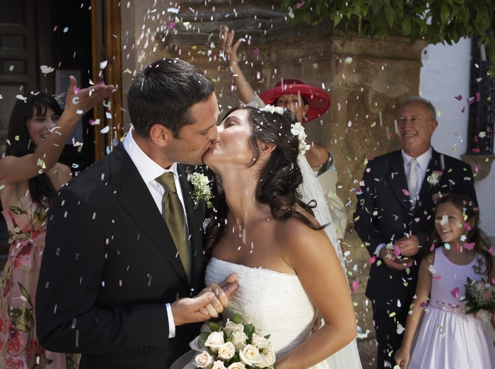 Bride and Groom Kissing with Confetti