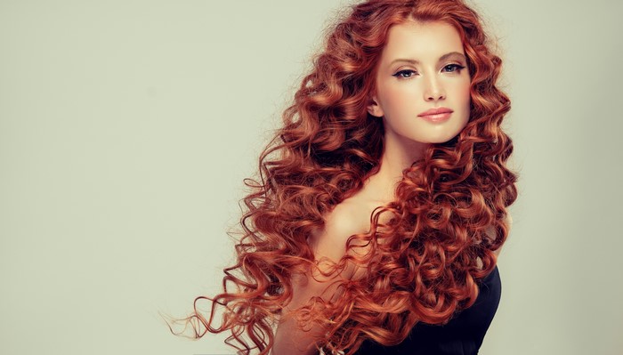 Redhead girl with long curly hair