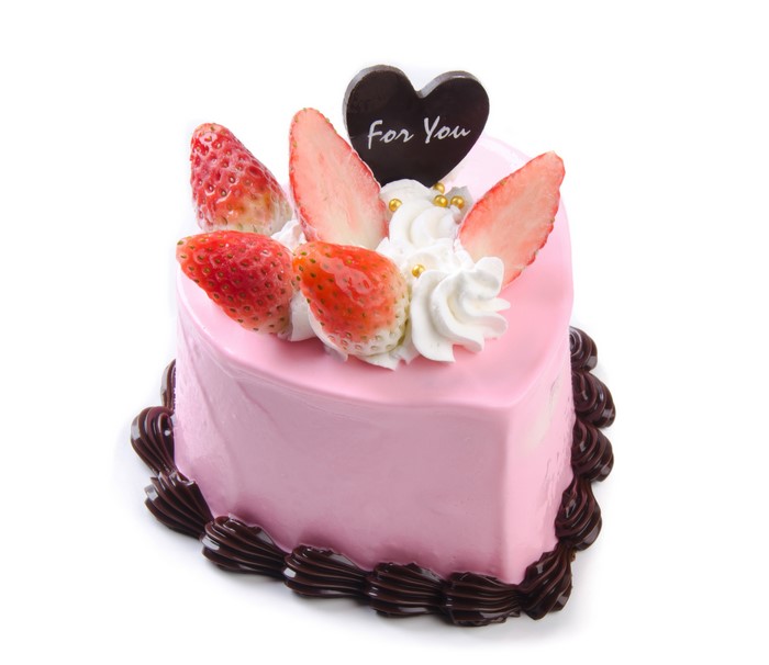 Heart-shaped strawberry cake with "For You" topper