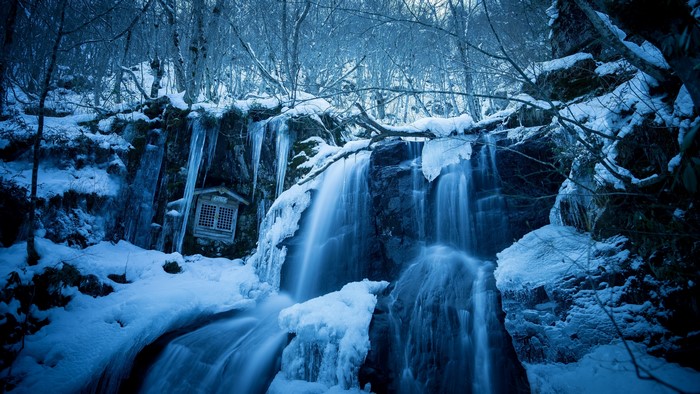 Winter waterfall with shrine and icicles