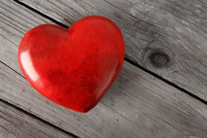 Red heart on weathered wood planks