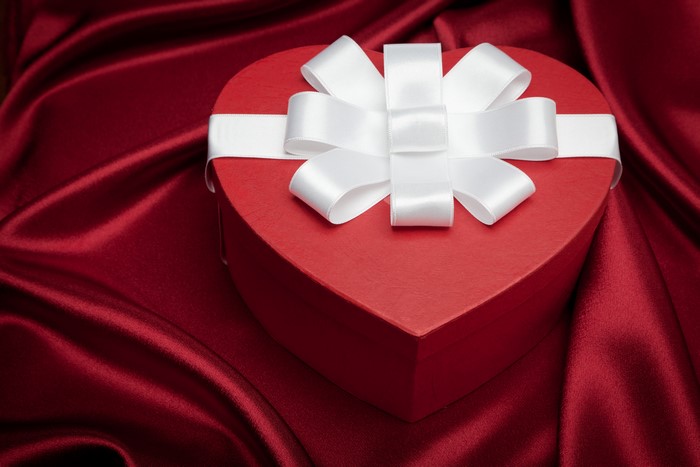 Red Heart Gift Box with White Bow on Red Silk